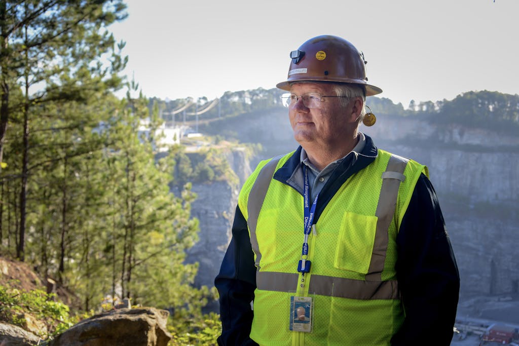 Employee in front of quarry