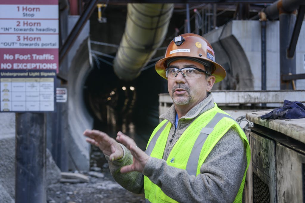 Employee in front of tunnel